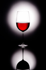 glass of red wine on black background