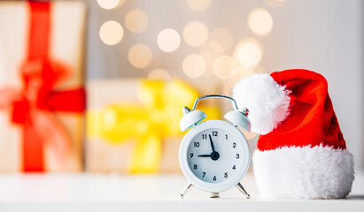 Vintage Alarm clock in Santa Claus hat with Christmas gift