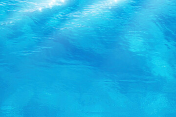 Fototapeta na wymiar Clear transparent blue water texture; beautiful summer tropical holiday suny sandy beach background