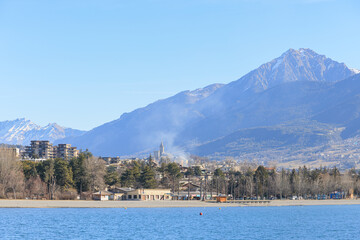 A scenics view of the Embrun, France lake with snowy mountains range in the background under a...
