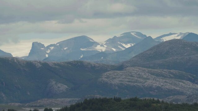 Mountainscape And Alps Against Cloudy Sky In Sleneset, Nordland Norway. Wide Shot