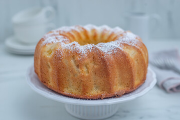 Lemon bundt cake drizzled with powdered sugar glaze