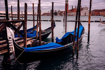 Gondolas in Venice on sunset next to San Marco square. Famous landmark in Italy