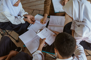 view from above the teacher guides students doing assignments in the book