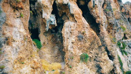 Eroded mountain rock close up. Weather-eroded stone texture. Mountain cliff relief.