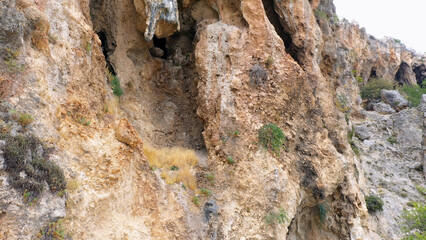 Eroded cliff close up. Rocky mountain detailed view. Huge weathered rock.