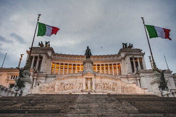 Fototapeta na wymiar Imposing monument Altare della Patria or Vittoriano with fluttering Italian flags is a fine example of renaissance architecture. Commanding Fatherland Altar in commemoration of Italy 's unification