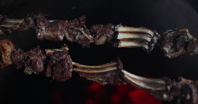 Pork ribs are prepared on a tandoor, a close-up