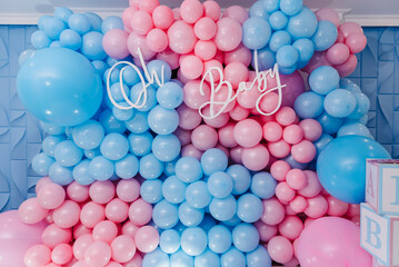Baby Shower party decor. Photo zone, arch with pink and blue balloons, cubes for gender party. Boy or girl. Know gender of unborn child. Happiness of parenthood. Background, wall with text oh baby. - obrazy, fototapety, plakaty