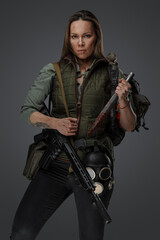 Shot of Mercenary woman in setting of post apocalypse looking at camera.