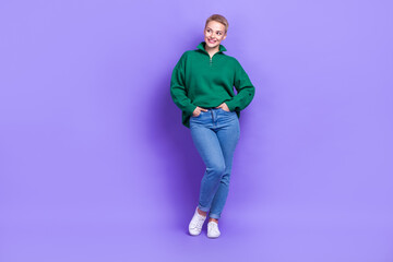 Full body photo of cheerful satisfied lady put hands pockets look empty space isolated on violet color background