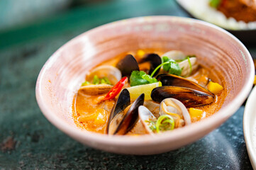 bowl of hot and delicious seafood soup on table