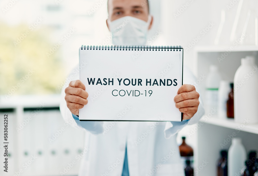 Aufkleber you know what you need to do. a scientist holding a sign with wash your hands on it in a laboratory.