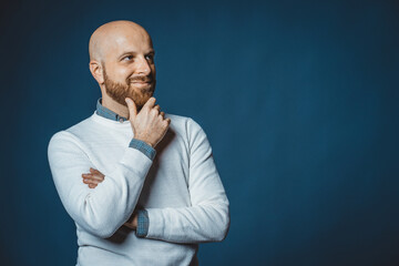 Photo of a caucasian nice guy with beard and blue background