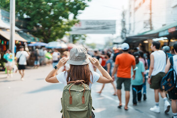 woman traveler visiting in Bangkok, Tourist with backpack and hat sightseeing in Chatuchak Weekend...
