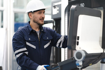 Industrial engineer operating modern CNC milling machine at a metalworking factory. Metalwork technician working with skill on accurate, precision automated machinery in lathe or cut steel. copy space © Nassorn