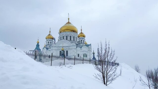 Belogorsky St. Nicholas Orthodox Missionary Monastery. Russia, Perm Krai, Belaya Gora. The temple on the hill in winter. Monastery on the background of snow. 4K