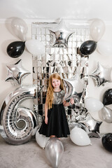 Happy child celebrating a birthday party 6 years. Photo wall, photo zone decoration white, black,...