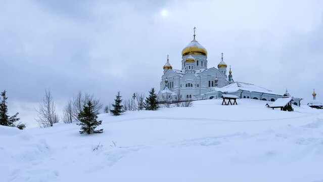 Belogorsky St. Nicholas Orthodox Missionary Monastery. Russia, Perm Krai, Belaya Gora. The temple on the hill in winter. Monastery on the background of snow. 4K