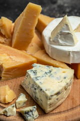 Parmesan. Cheeses set dor blu chedar camamber brie. Different types of cheese with knife on a light background. place for text, top view