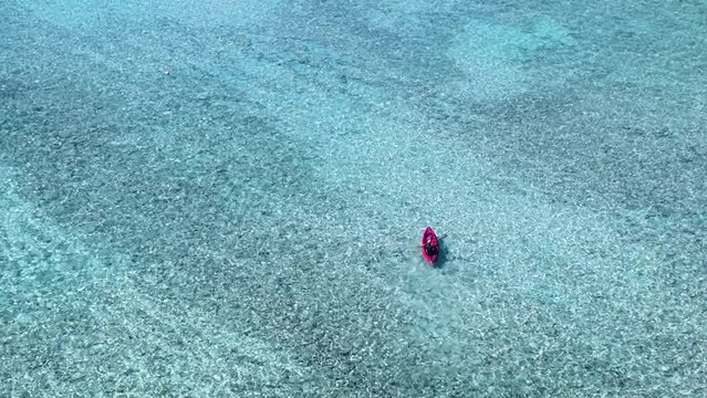 The Aerial view of woman traveller exploring calm tropical bay ,Travel and Active Lifestyle concept