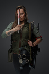 Portrait of brown haired woman mercenary in setting of post apocalypse.