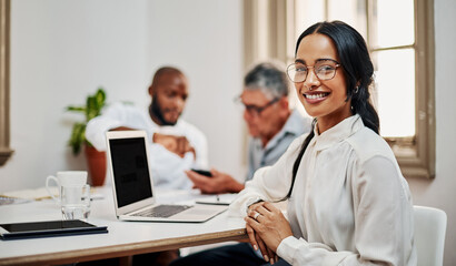 The best colleagues always have your back. Portrait of a young businesswoman having a meeting with colleagues in a modern office.