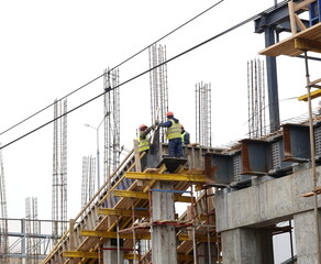 A construction workers on construction site and sky background. Russia, 2022