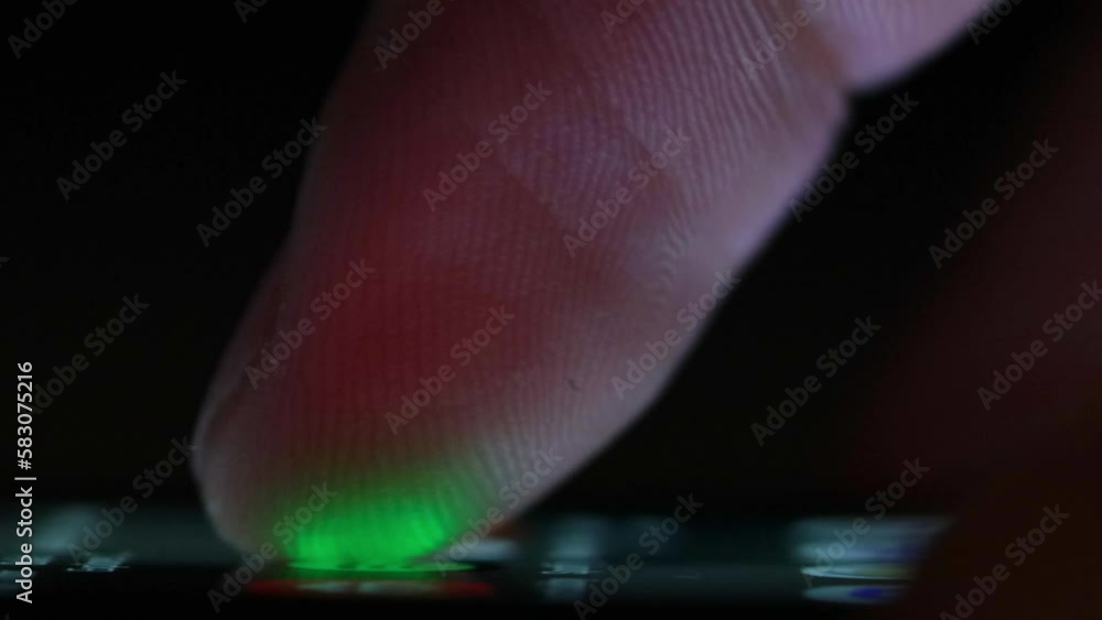 Poster finger scrolls smartphone screen in the dark illuminated by screen light. searching news and browsin