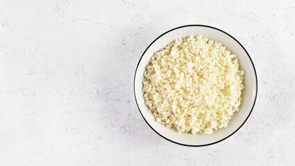 Raw cauliflower rice in bowl