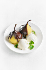 Poached pears with chocolate sauce and ice cream