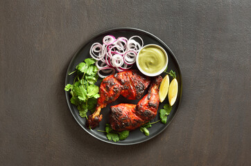 Tandoori chicken served with cilantro and onion