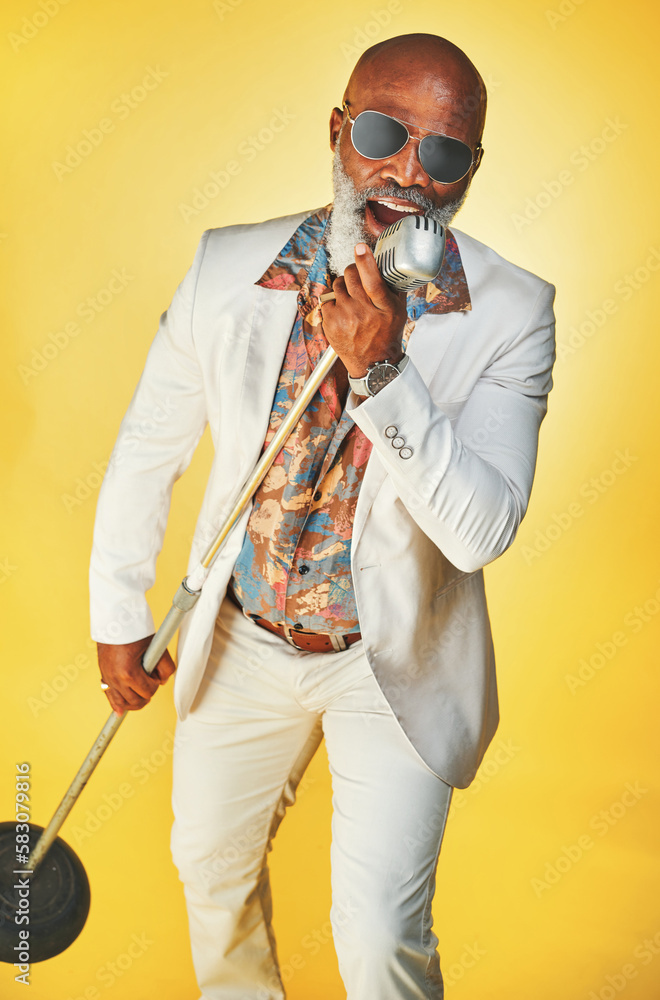 Poster singing with emotion and passion. studio shot of a senior man wearing vintage clothes while singing 