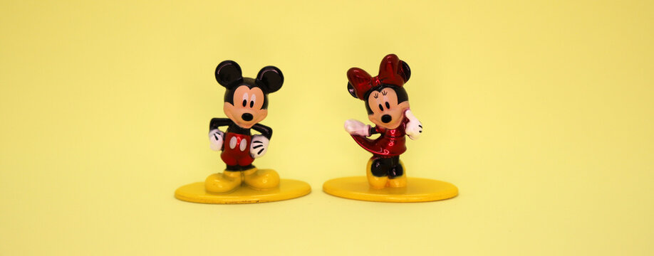 Mickey Mouse and Minnie Mouse. Cartoon characters from Walt Disney Pictures Studios. Mickey is Minnie Mouse's boyfriend. Mickey Mouse's house. Classic Mickey. Banner. Car. Metal dolls. Isolated yellow