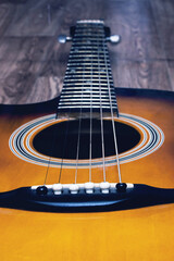 Obraz premium Acoustic guitar on a wooden background closeup