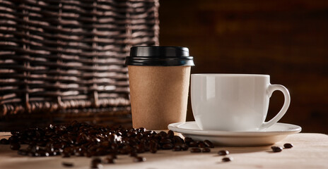 Coffee compliments any meal. Closeup shot of a paper cup and teacup surrounded by coffee beans.