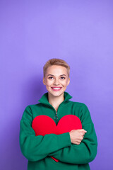 Vertical photo of blonde hair lady wear green stylish fleece jumper hug her valentine day heart postcard look up isolated on purple color background