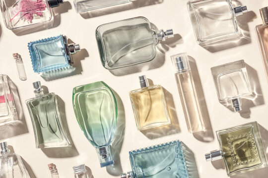 This photo showcases a top-down view of numerous transparent glass perfume bottles, creating a visually appealing and elegant display.