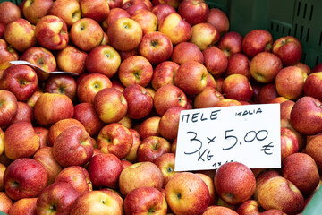 Apples with a handwritten price sign at a street market in Piove di Sacco, Padova, Veneto, Italy