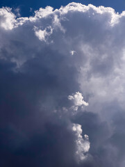 Momentary luminous prominence of portions of cloud early on an afternoon in spring, southwest Florida, for motifs of ephemeral phenomena, contrast, and illumination