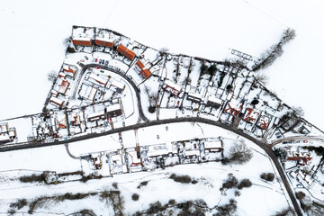 Aerial view directly above snow covered homes in a village community