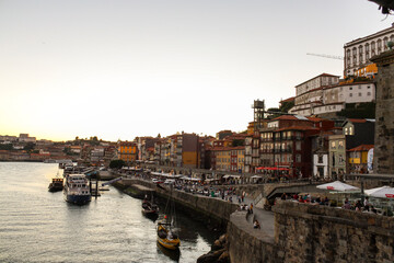 View of the river port of Porto, Portugal, at sunset with boats