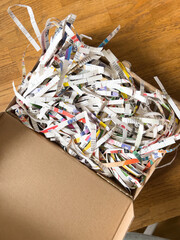 A close-up of a chaotic heap of shredded newspaper, cardboard and other recycled materials in an...