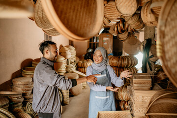 woven bamboo seller presenting her product to customer in the shop