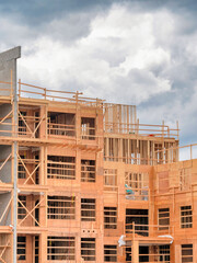 Apartment building under construction on cloudy sky background