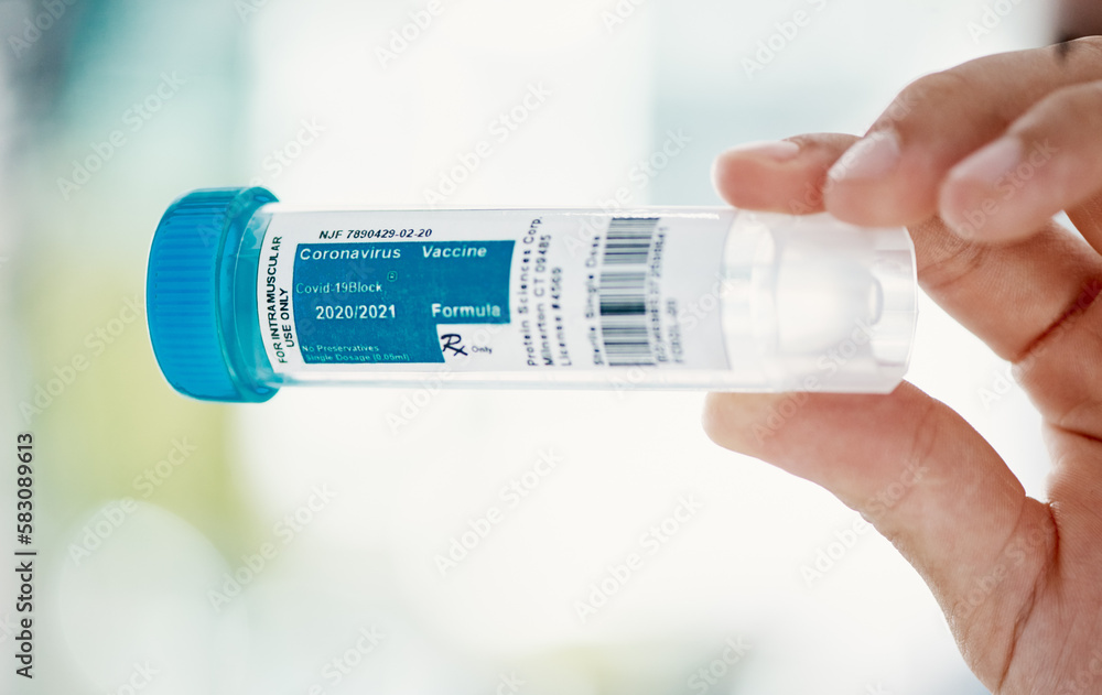 Poster hope in a bottle. a scientist holding a container with coronavirus vaccine on it.