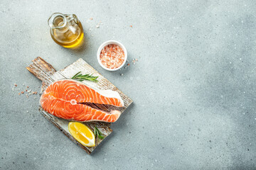 Salmon steak raw fish prepared for cooking fresh rosemary, spices, sea salt on a light background. banner, menu, recipe place for text, top view