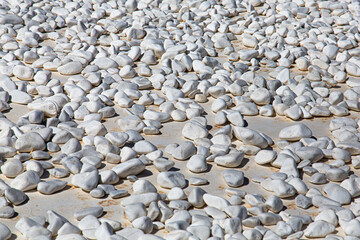 pebbles on the roof of a house in Santorini