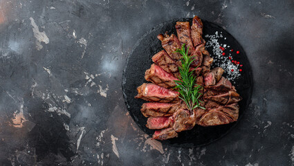 Grilled beef steak medium rare on a dark background. Long banner format. top view