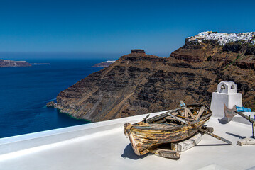 old boat on house roof in santorini